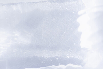 Blurred ripple water texture on white background. Shadow of water on sunlight. Mockup for product, spa or travel background. Marble water surface as wallpaper background
