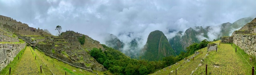 grass and sky of the ancient city of machu picchu with foggy	