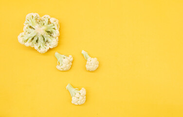 Fototapeta na wymiar Cauliflower isolated on yellow background, vegetable concept of cooking, top view