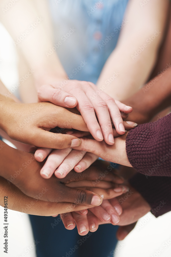 Sticker Strength in numbers. Cropped shot of a group people putting their hands together in unity.