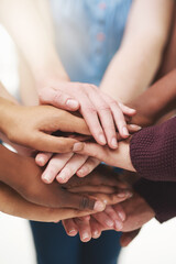 Strength in numbers. Cropped shot of a group people putting their hands together in unity.