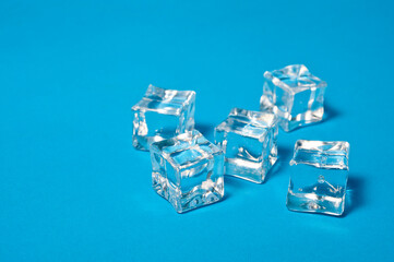 Clear ice cubes for cooling drinks on a blue background.