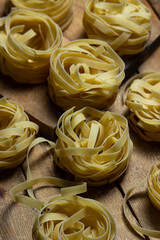 Pasta nests on a wooden background. Shape of pasta. traditional cooking