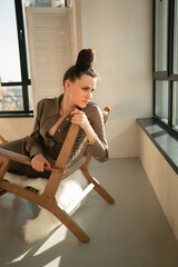 Ukrainian brunette girl sitting in a wooden chair portrait

Young brown-haired woman beautiful hands slender legs reception beige interior fashionable dress has wall hairstyle beautiful leather 
