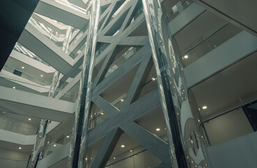 Obraz premium View from below of interior structure in metal and glass of an empty modern building without people