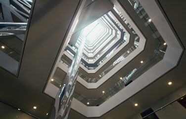 Obraz premium View from below of interior structure in metal and glass of an empty modern building without people