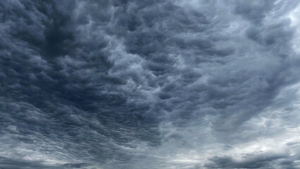 Dark blue cloudy sky with low clouds