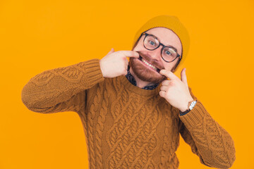 young caucasian man making a goofy face by widening his face with his own fingers. High quality photo