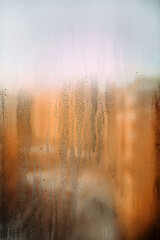 background texture of a wet window in drops with sun after rain