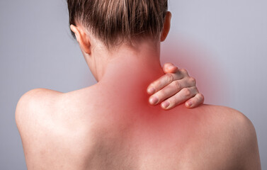 Naklejka premium Woman suffering from neck pain. Head back with red point closeup. Health problems, sedentary lifestyle concept. High quality photo