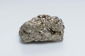 Raw crystalline pyrite (iron pyrite, fool's gold). Mineral pyrite from the group of sulfides. The mineral pyrite on a white background