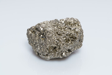 Raw crystalline pyrite (iron pyrite, fool's gold). Mineral pyrite from the group of sulfides. The mineral pyrite on a white background