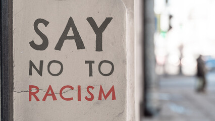 Say no to racism. The inscription on the wall of the building.