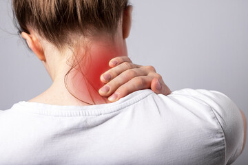 Woman suffering from neck pain. Head back with red spot closeup. Health problems caused by...