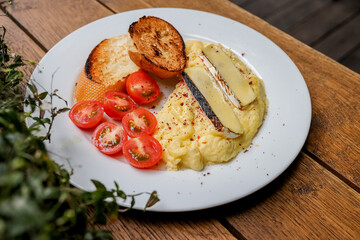Waffles breakfast with fruit and vegetables omelet camembert