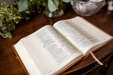 Open Bible on Brown Wood Table