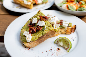 Granola in glass toast guacamole to go