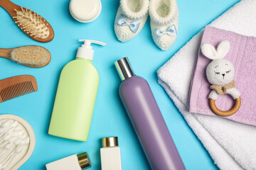 Flat lay composition with baby cosmetic products on light blue background