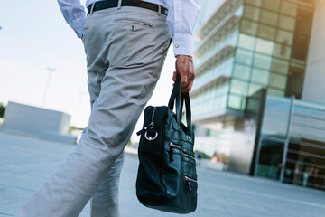 Anonymous businessman holding briefcase going to work