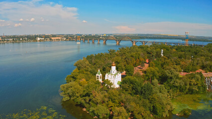 Beautiful summer landscape while sunset over the river with a church. Beautiful  urban environment...