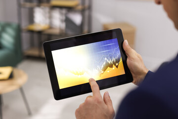 Fototapeta na wymiar Businessman working with tablet in office, closeup. Forex trading