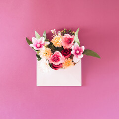 Spring flowers concept in an envelope. Flat lay background.