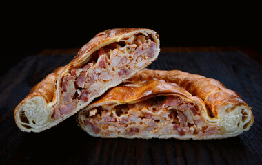 Meat village pie lies on a wooden surface.