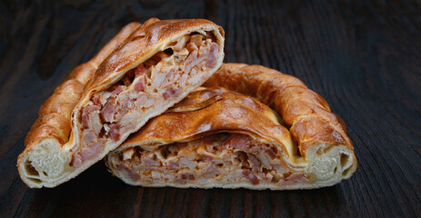 Meat village pie lies on a wooden surface.