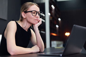 Stylish elegant woman in glasses with laptop in modern office. Bussiness concept.