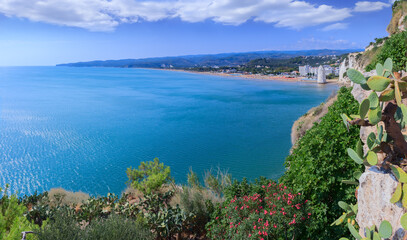 Gargano coast: bay of Vieste in Apulia, Italy. Castello or Scialara beach: it is overshadowed by the Swabiam Castle and the Pizzomunno Monolith (from the local dialect: peak of cape of the world).