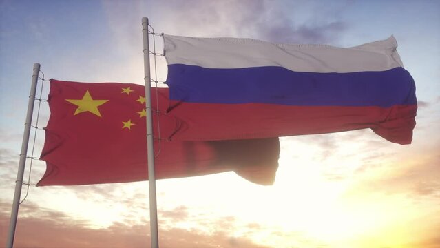 Russia and China flag on flagpole. Russia and China waving flag in wind. Russia and China diplomatic concept