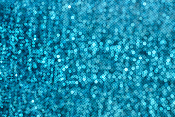 Bokeh texture of shiny sparkling lurex fabric blue color.