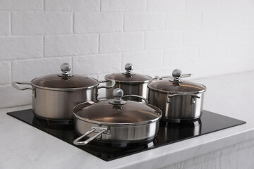 Set of new clean cookware on cooktop in kitchen
