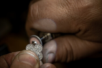 Different goldsmiths tools on the jewelry workplace. Jeweler at work in jewelry. Desktop for craft jewelry making with professional tools. Close up view of tools.