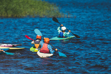 Kids learn kayaking, canoeing whitewater training in the lake river, children practicing paddling,...