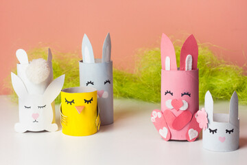 DIY bunny for kids. Easter home activities. Handmade cute toy rabbits. Reuse concept. Art from paper tube.