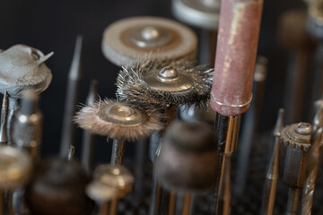 Front view of a set of various tools placed on a wooden desk in a workshop
