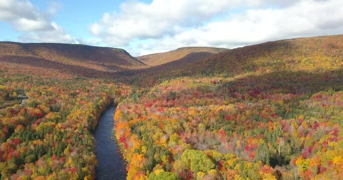 Aerial views of the famous Cabot Trail along the North River, Oregon, Cape Breton, Nova Scotia in Autumn. Fall foliage of the mountains with multi-colored deciduous trees. 