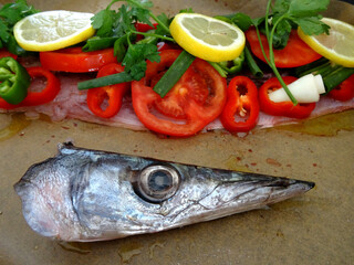 Ready to grill European barracuda (locally known as iskarmoz, known also as mediterranean barracuda, Sphyraena sphyraena) dish prepared with vegetables in Bodrum, Turkey.              