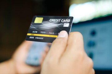 Woman use smart phone and holding credit card with shopping online.