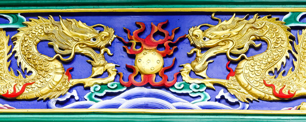 Ngong Ping, Hong Kong, China - September 17 2019: Po Lin monastery : two golden dragons on a blue background