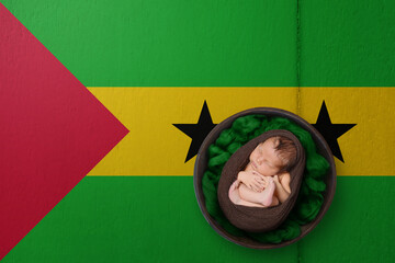 Newborn portrait on background in color of national flag. Patriotic photography concept. Sao Tome