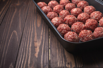Raw meatballs on Baking trays are prepared and ready for baking in the oven. selective focus