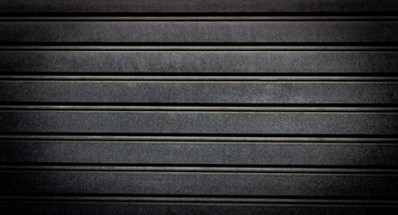 Dark metal background. Detail of a garage door.