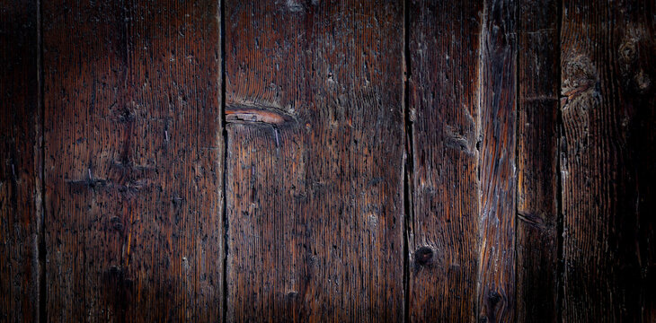 Dark wooden background. Detail of an ancient Venetian door.