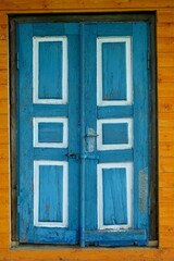 Close-up of old door painted blue and white.