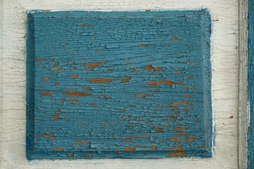 Naklejka premium Close-up of flaking blue paint on a wooden door