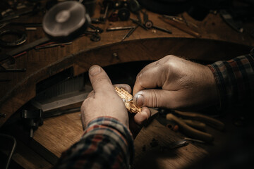 Different goldsmiths tools on the jewelry workplace. Jeweler at work in jewelry. Desktop for craft...