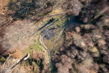 Aerial view of a path or road going through a forest in South Wales