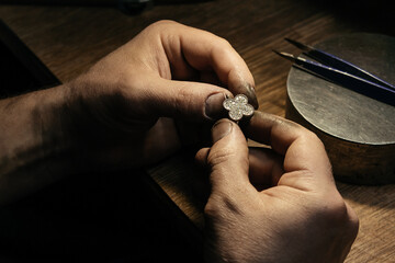 Different goldsmiths tools on the jewelry workplace. Jeweler at work in jewelry. Desktop for craft...